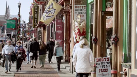 Tourists-on-Broadway-Street-in-Nashville,-Tennessee-during-the-day-with-medium-shot-video-stable