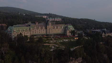 aerial-view-blue-hours-of-Fairmont-Le-Manoir-Richelieu,-Charlevoix,-Quebec-Canada-famous-historical-landmark-at-sunset