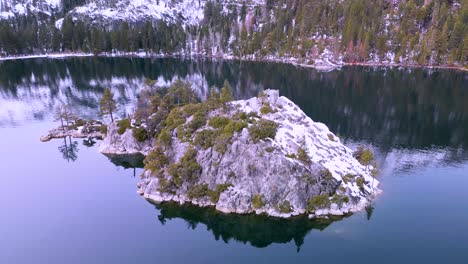 Aerial-view-of-Fannette-Island-water-reflection-with-mountains,-Emerald-Bay,-Lake-Tahoe,-California