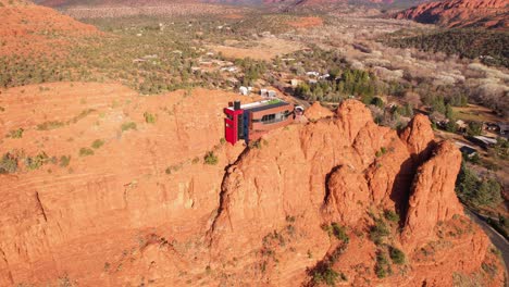 Sedona-AZ-USA,-Aerial-View-of-Modern-House-Atop-of-Red-Sandstone-Cliff,-Futuristic-Home-in-Desert-Landscape,-Revealing-Drone-Shot