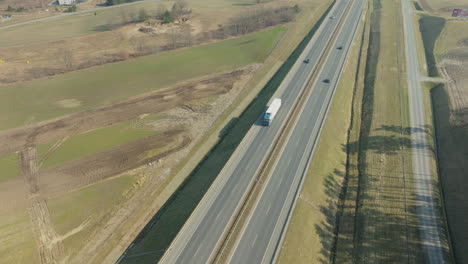 Cars-And-Truck-Driving-Through-The-Highway-Along-The-Countryside-Road-In-Summer