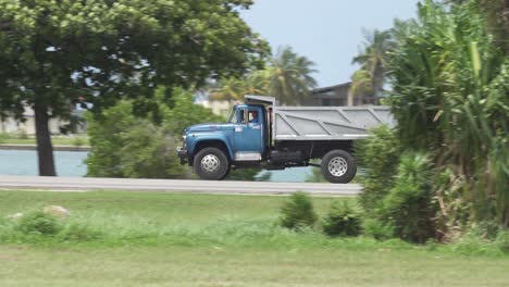 Russian-ZIL-130-truck-driving-in-Havana,-Cuba,-panning-shot