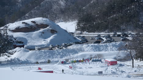 Cars-in-parking-lot-at-Daegwallyeong-Sky-Ranch,-Korea,-establishing-wide-view