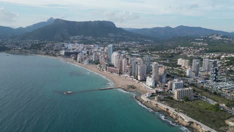 Calpe-City-Skyline-and-Coast-in-Alicante,-Costa-Blanca,-Spain---Aerial-4k