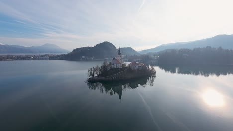 Aerial-shot-of-Bled-Church-between-Bled-Lake-in-Slovenia