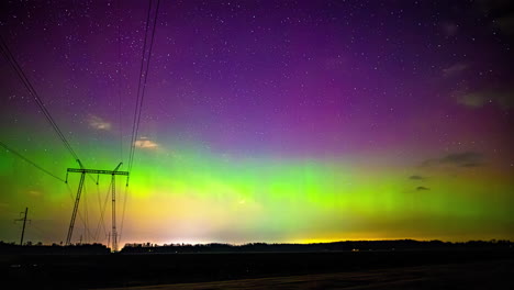 Glowing-Northern-lights-sky-with-stars,-above-the-countryside---Time-lapse-shot
