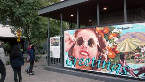 Greeting-mural-in-Palm-Springs,-California-with-tourists-and-stable-video