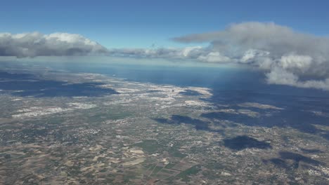 Aerial-far-view-of-Valencia-city,-Spain,-shot-from-an-airplane-cabin-at-3000m-high