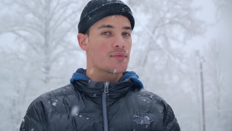 Good-Looking-Caucasian-Man-With-Beanie-Stands-Outside-During-Snowfall---Slow-Motion-Close-Up