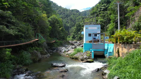 Aerial-approaching-shot-of-Hydroelectric-power-plant-at-rocky-river-in-jungle-of-Dominican-Republic