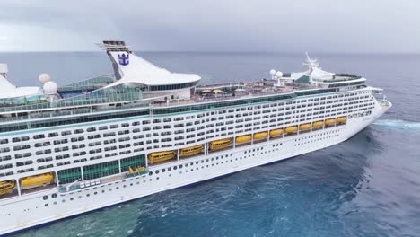 Flying-around-Royal-Caribbean-Explorer-of-the-Seas-cruise-ship-navigating-in-open-ocean