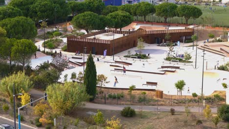 People-stunting-in-skatepark-of-Montpellier,-France-aerial-view