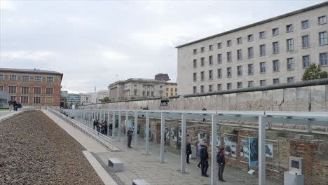 Tourists-Visit-The-Berlin-Wall-Monument-At-Topography-of-Terror-In-Berlin,-Germany