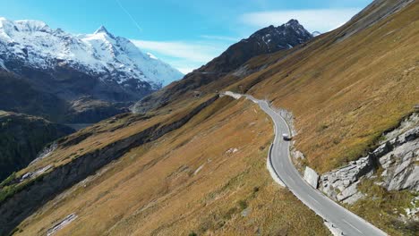 Camper-drives-Grossglockner-High-Alpine-Road-in-Austria-Alps---Aerial-4k