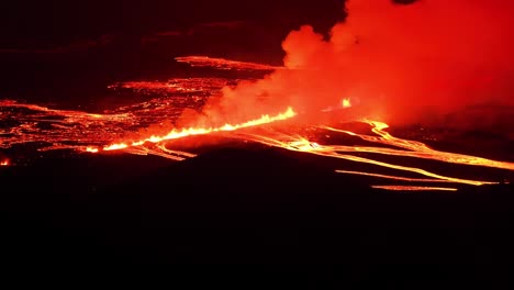 Fissure-volcanic-eruption-with-large-smoke-cloud-in-Iceland-at-night,-Svartsengi