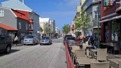 Street-Life-in-Reykjavik,-Iceland-on-Sunny-Spring-Day,-Traffic-and-People-on-Sidewalks