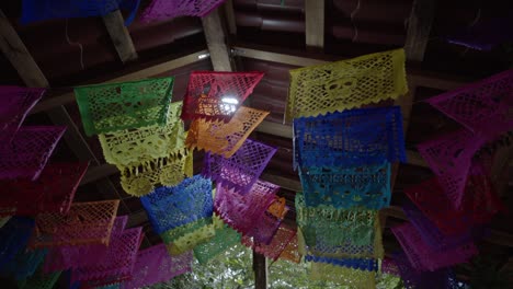 Mexican-decoration-for-Day-of-the-Dead,-Colorful-paper-laces-poked-with-traditional-patterns-hanging-on-the-ceiling