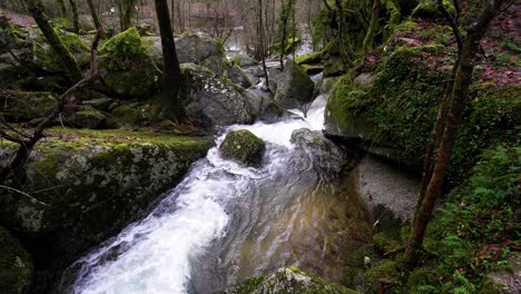 Moss-covered-boulders-in-Barrias-river-cascade,-Felgueiras-Portugal