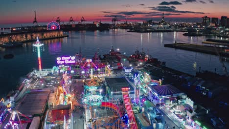 Twilight-aerial-view-over-Winter-Park-Genoa-illuminated-with-neon-lights