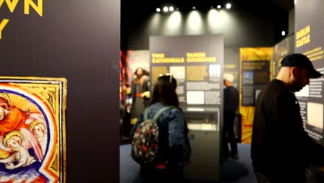 Panning-shot-of-sign-in-Dublinia-Viking-Museum-with-tourists-exploring-pieces