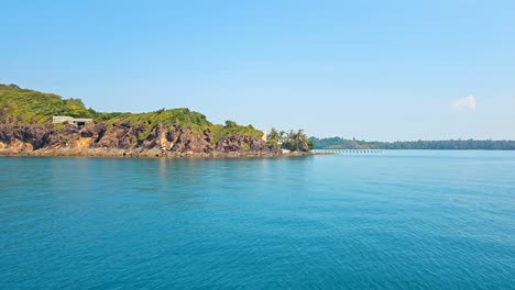 Tranquil-beach-scene-on-Koh-Chang-private-island-with-clear-turquoise-waters-and-lush-greenery,-in-Thailand