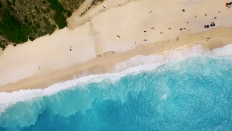 Orbiting-drone-shot-of-the-beachfront-of-Myrtos,-located-in-Pylaros-in-the-island-of-Kefalonia-be-the-Ionian-Sea-in-Greece