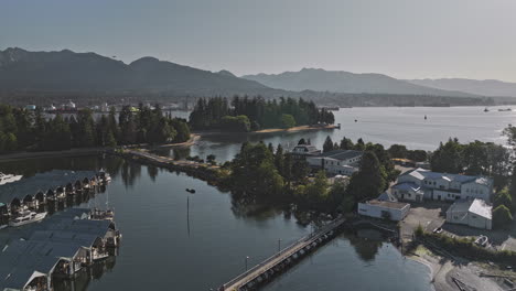 Vancouver-BC-Canada-Aerial-v76-drone-flyover-Stanley-Park-capturing-yacht-club,-North-shore-industrial-site,-mountains,-and-views-of-Lions-Gate-Bridge---Shot-with-Mavic-3-Pro-Cine---July-2023
