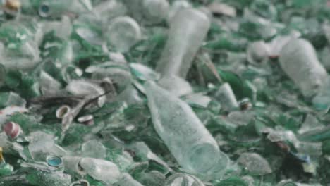 detail-of-green-and-white-glass-bottles-abandoned-on-a-mountain-of-garbage