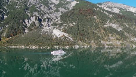 Boat-Sails-at-Mountain-Lake-Achensee-in-Tyrol,-Austria---Aerial-4k