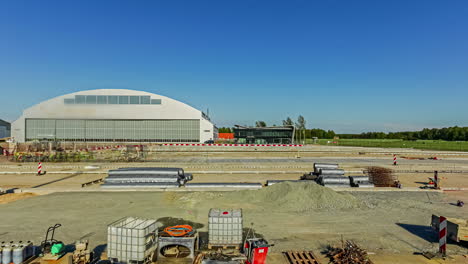 Long-time-timelapse-of-machines-and-people-constructing-asphalt-at-a-airfield