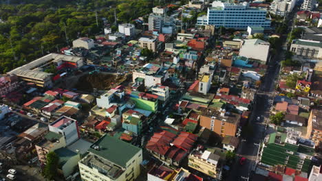 Aerial-view-tilting-over-Santa-Cruz-and-the-University,-toward-the-Makati-Skyline