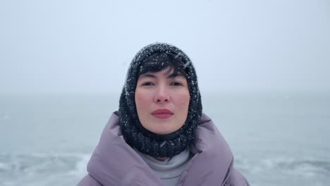 Close-Up-of-Beautiful-Caucasian-Woman-on-the-Beach-in-Snowfall
