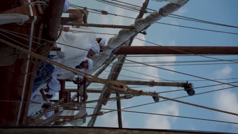 Sailors-in-traditional-costume-on-a-vintage-ship-at-Abu-Dhabi's-Maritime-Festival-March-2024---vertical