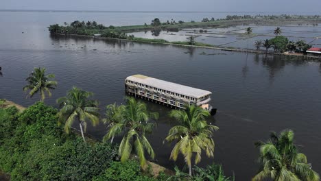 Aerial-drone-view-cruises-in-the-middle-of-water-with-lots-of-people-sitting-and-coconut-trees-around