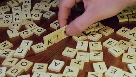 Word-KING-is-formed-with-wooden-Scrabble-letter-tiles-on-table-top