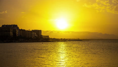 Golden-sunset-on-the-Alboran-Sea,-beautiful-timelapse-in-Malaga,-Spain