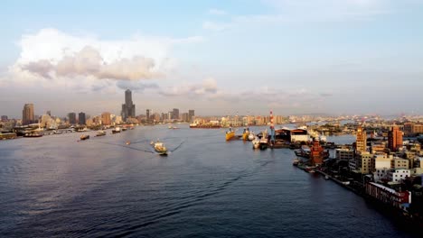 Golden-hour-view-of-a-busy-port-cityscape-with-numerous-boats-and-waterfront-buildings