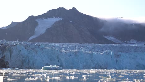 Birds-Flying-Above-Glacier-Ice-and-Glacial-Lagoon,-Fjortende-Julibreen-Glacier,-Svalbard,-Norwegian-Northern-Territories