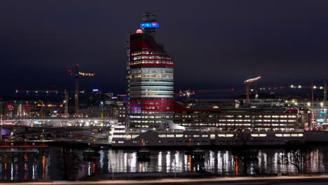 Modern-buildings-illuminated-at-night-on-Gota-Alv-waterfront,-Gothenburg