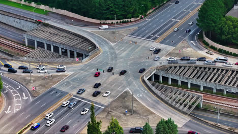 Aerial-top-down-of-busy-multi-lane-junction-and-tracks-underpass-in-American-Town