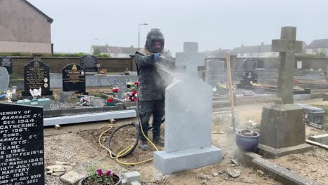 Man-sandblasting-headstone-grave-marker-in-Cemetery