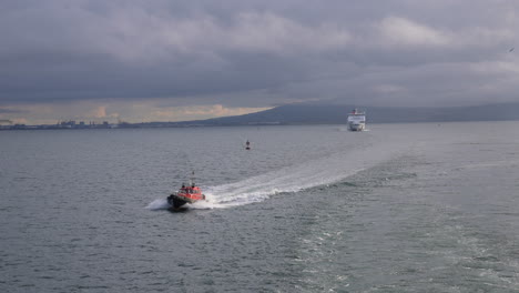 Fishing-Boat-and-Cruise-Ship-Sailing-Just-Outside-Belfast-Harbour,-Northern-Ireland-UK,-Slow-Motion