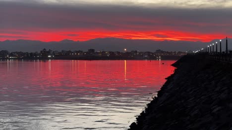 wonderful-orange-color-sunset-at-the-beach-seaside-wide-view-landscape-scenic-sea-coast-amazing-reflection-and-mountain-in-background-the-port-anzali-in-middle-east-asia-marine-concept-red-sky-cloud