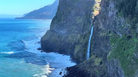 Véu-da-Noiva-waterfall-in-Madeira-island-on-a-sunny-day-spill-into-the-Atlantic-ocean