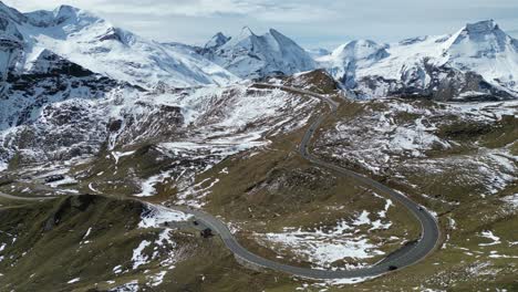 Grossglockner-High-Alpine-Road-and-Snowy-Mountain-Peaks-in-Austria-Alps---Aerial-4k-Circling