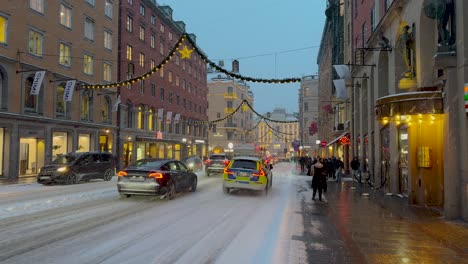 Static-shot-of-busy-Kungsgatan-street-in-Stockholm,-Sweden-with-Christmas-decorations,-winter-atmosphere