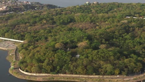 The-aerial-drone-is-moving-towards-the-view-where-the-road-is-visible-and-the-big-lake-and-many-houses-are-also-visible