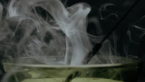 A-smoky-relaxing-scene-with-a-bowl-of-essence-burning-on-a-stick-,-making-soft-calm-waves-of-smoke