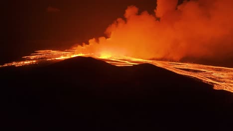 Active-fissure-eruption-lights-up-cloud-and-sky-with-orange-glow,-Iceland