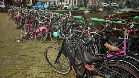 Bicycles-placed-next-to-each-other-on-a-bridge-next-to-a-canal-in-the-Netherlands